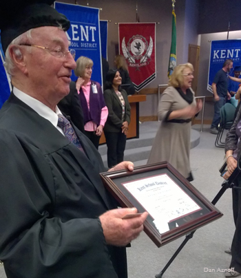 Henry Friedman shows off his high school diploma at the offices of the Kent School District.