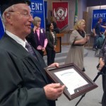 Henry Friedman shows off his high school diploma at the offices of the Kent School District.